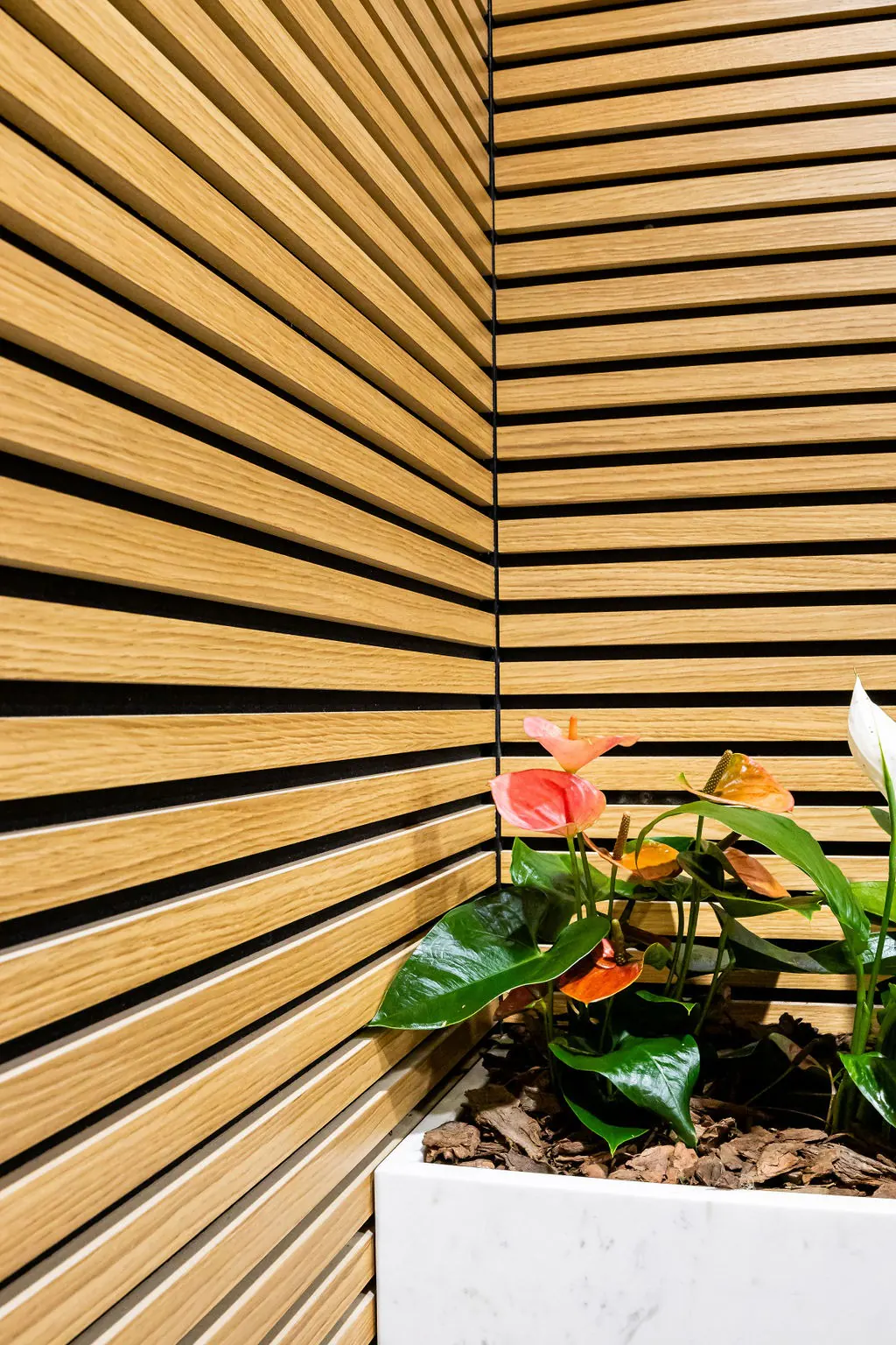 Close-up of AcoustiSlat natural wood-look oak slats meeting in a corner
